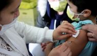 FILE PHOTO: A medical worker administers a dose of a coronavirus disease (COVID-19) vaccine to a child at a vaccination centre in Les Pavillons-sous-Bois, near Paris, France, December 18, 2021. REUTERS/Sarah Meyssonnier/File Photo
