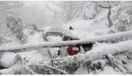 Vehicles stuck under fallen trees are seen on a snowy road, in Murree, northeast of Islamabad, Pakistan in this still image taken from a video January 8, 2022. PTV/REUTERS 