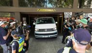 Members of the media waiting for a sighting of Serbian tennis player Novak Djokovic surround a departing transport vehicle exiting the Park Hotel, in Melbourne, Australia, January 10, 2022. Reuters/Asanka Brendon Ratnayake