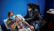 A woman receives a booster dose of Covaxin, a coronavirus disease (COVID-19) vaccine manufactured by Bharat Biotech, at a vaccination centre in New Delhi, India, January 10, 2022. REUTERS/Adnan Abidi
