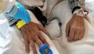 A medical specialist treats a patient in a ward for people suffering from the coronavirus disease (COVID-19) at a city hospital in Gliwice, Poland, December 2, 2021. Picture taken December 2, 2021. Grzegorz Celejewski/Agencja Wyborcza.pl via REUTERS