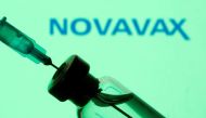 A vial and sryinge are seen in front of a displayed Novavax logo in this illustration taken January 11, 2021. REUTERS/Dado Ruvic/Illustration

