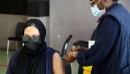 A healthcare worker administers the coronavirus disease (COVID-19) vaccine to a pregnant woman, amidst the spread of the SARS-CoV-2 variant Omicron, in Johannesburg, South Africa, December 9, 2021. REUTERS/ Sumaya Hisham