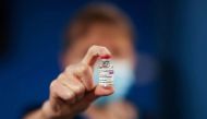 A healthcare worker holds a vial of the AstraZeneca/Oxford University COVID-19 vaccine at the Pentland Medical Practice in Currie, Scotland, Britain, January 7, 2021. REUTERS/Russell Cheyne/Pool

