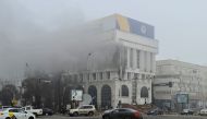 A view shows smoke billowing from inside a building that houses several TV and radio stations following the protests triggered by fuel price increase, in Almaty, Kazakhstan January 6, 2022. Picture taken January 6, 2022. REUTERS