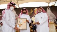 Chief of Special Amiri Diwan H E Khalid bin Shaheen bin Ghanim Al Ghanim receiving a commemorative shield during his visit to Marmi Festival at Sabkhat Marmi in Sealine.