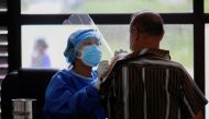 File photo of a health worker speaks to a man as she gives a dose of the Chinese Sinopharma vaccine against the coronavirus disease (Covid-19) in Kathmandu, Nepal, July 6, 2021. Reuters/Navesh Chitrakar/File Photo
