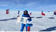 Sheikha Asma Al Thani at the South Pole, Antarctica, holding the UNHCR flag ©️ Nirmal Purja