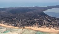 A general view from a New Zealand Defence Force P-3K2 Orion surveillance flight shows heavy ash fall over Nomuka in Tonga after the Pacific island nation was hit by a tsunami triggered by an undersea volcanic eruption January 17, 2022. New Zealand Defence Force/Handout via REUTERS

