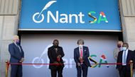 South African President Cyril Ramaphosa and Dr. Patrick Soon-Shiong cut a ribbon, while Premier of the Western Cape Alan Winde looks on, during the launch of NantSA, a future vaccine manufacturing facility designed to accelerate the production of pharmaceuticals, in Cape Town, South Africa, January 19, 2022. REUTERS/Shelley Christians
 