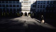 A person wearing a protective face mask walks on a street in Munich, Germany, January 19, 2022. REUTERS/Lukas Barth