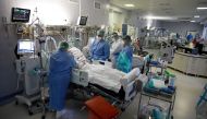 Medical staff members treat patients inside the coronavirus disease (COVID-19) ward at the Central Clinical Hospital of the Ministry of Interior and Administration in Warsaw, Poland, January 11, 2022. REUTERS/Kacper Pempel

