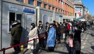 People line up to take nucleic acid tests at a testing site outside a hospital following the coronavirus disease (COVID-19) outbreak in Beijing, China January 17, 2022. REUTERS/Carlos Garcia Rawlins

