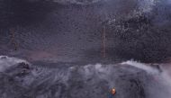 Members of the INVOLCAN technical team take measurements next to the crater of the Cumbre Vieja volcano, in Cabeza de Vaca, on the Canary Island of La Palma, Spain, January 21, 2022. Picture taken with a drone. REUTERS/Borja Suarez