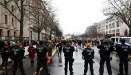 Police officers stand guars while demonstrators protest near of the Reichstag building as the German parliament debates mandatory coronavirus disease (COVID-19) vaccinations, in Berlin, Germany, January 26, 2022. REUTERS/Christian Mang
