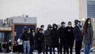 People line up to get a throat swab test at a temporary COVID-19 testing center as the coronavirus disease (COVID-19) continues in Beijing, China, January 26, 2022. REUTERS/Thomas Peter/File Photo