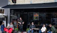 File photo: People enjoy outdoor service as cafes and restaurants reopen due to COVID-19 restrictions easing in Roskilde, Denmark April 21, 2021. Claus Bech/Ritzau Scanpix/via Reuters