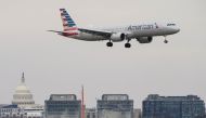 An American Airlines aircraft flies past the U.S. Capitol before landing at Reagan National Airport in Arlington, Virginia, U.S., January 24, 2022. REUTERS/Joshua Roberts


