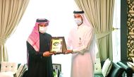 Minister of Finance H E Ali bin Ahmed Al Kuwari receiving the new logo from Chairman of the General Authority of Customs H E Ahmed bin Abdullah Al Jamal.