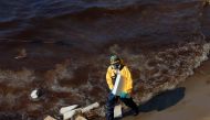 A worker cleans oil spills caused by a leak from an undersea pipeline 20 km (12.4 miles) off Thailand's eastern coast at Mae Ramphueng beach in Rayong province, Thailand, January 29, 2022. Reuters/Soe Zeya Tun