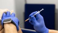 A woman gets a dose of Comirnaty, the Pfizer-BioNTech vaccine against the coronavirus disease (COVID-19), one day before the start of compulsory vaccination in Austria during the ongoing coronavirus disease (COVID-19) pandemic, at a vaccination centre in Salzburg, Austria, January 31, 2022. REUTERS/Lukas Barth