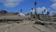 A general view shows damaged buildings and landscape covered with ash following the volcanic eruption and tsunami in Kanokupolu, Tonga, January 23, 2022. Tonga Red Cross Society/Handout via Reuters
