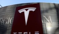 A logo of the electric vehicle maker Tesla is seen near a shopping complex in Beijing, China January 5, 2021. REUTERS/Tingshu Wang/File Photo

