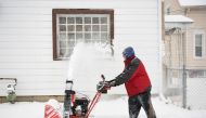 Ken Sayen helps clear the roads and sidewalks in his neighborhood during a snowstorm in Toledo, Ohio, U.S., February 3, 2022. REUTERS/Gaelen Morse


