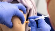 A woman gets a dose of Comirnaty, the Pfizer-BioNTech vaccine against the coronavirus disease (COVID-19), one day before the start of compulsory vaccination in Austria during the ongoing coronavirus disease (COVID-19) pandemic, at a vaccination centre in Salzburg, Austria, January 31, 2022. REUTERS/Lukas Barth/File Photo