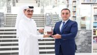 Minister of State and President of Qatar National Library H E Dr. Hamad bin Abdulaziz Al Kawari receiving the commemorative badge from Ambassador of Azerbaijan to Qatar Rashad Ismayilov.
