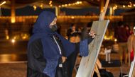 An artist painting at the exhibition ‘Art and Arabian Horses’.