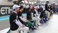 FILE PHOTO: Mercedes' Lewis Hamilton and other drivers take a knee before the race Pool via REUTERS/Kamran Jebreili


