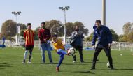 A child joins in a football game organised by the Aspire Zone Foundation at the Aspire Park.