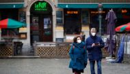 People wearing protective face masks walk at the Grand Place in Brussels, amid the rise of the coronavirus disease (COVID-19) cases due to the Omicron variant in Belgium, January 21, 2022. REUTERS/ Johanna Geron/File Photo