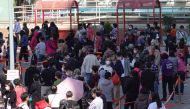 FILE PHOTO: People line up at a makeshift testing site for the coronavirus disease (COVID-19) following the outbreak, in HONG KONG, China February 11, 2022. REUTERS/Joyce Zhou/File Photo
