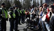 Police officers hold back a line of protesters as truckers and supporters continue to protest against the coronavirus disease (COVID-19) vaccine mandates, near the Canada and U.S. border crossing in Surrey, British Columbia, Canada, February 13, 2022. REUTERS/Jesse Winter
