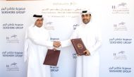 Qatar Racing and Equestrian Club Chairman Issa bin Mohammed Al Mohannadi and Seashore Group CEO Salem Saeed Al Mohannadi shake hands during the sponsorship signing ceremony.