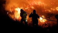 Firefighters battle a wildfire that has spread over more than 500,000 hectares in the northern province of Corrientes, in Portal San Antonio, Argentina, February 14, 2022.REUTERS/Sebastian Toba/File Photo