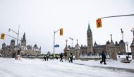 Police officers walk along Wellington Street as Canadian police worked to evict the last of the trucks and supporters occupying the downtown core, three weeks after a protest against coronavirus disease (COVID-19) vaccine mandates began in Ottawa, Ontario, Canada, February 20, 2022. REUTERS/Carlos Osorio
