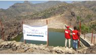QRCS volunteers and local residents at two of the water projects implemented by QRCS in Yemen.