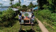 Student volunteers ride on their makeshift trolley which serves as a mobile library for children, in Tagkawayan, Quezon Province, Philippines, February 15, 2022. REUTERS/Lisa Marie David