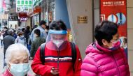 People are seen wearing face masks at the first day of a vaccine passport roll out, following the coronavirus disease (COVID-19) outbreak, in Hong Kong, China February 24, 2022. REUTERS/Tyrone Siu
