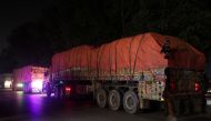 Supply trucks carrying aid shipments containing wheat to Afghanistan, move in a convoy near Lahore, Pakistan February 23, 2022. REUTERS.