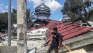 A man checks the damage of the destroyed Raya Kajai mosque after an earthquake in Kecamatan Talamau on Sumatra Island, Indonesia, February 25, 2022. Antara Foto/Altas Maulana via REUTERS