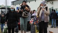 People arrive at the border crossing between Poland and Ukraine, after Russia launched a massive military operation against Ukraine, in Medyka, Poland, February 25, 2022. REUTERS/Kacper Pempel