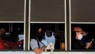 A cat along with people wearing face masks as protection against the coronavirus disease (COVID-19) ride a bus, in Manila, Philippines, March 1, 2022. REUTERS/Lisa Marie David