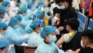 Medical workers inoculate students with the vaccine against the coronavirus disease in Qingdao. Reuters