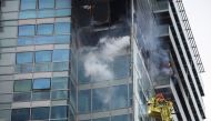 Firefighters extinguish a fire at a building in East London, Britain, March 7, 2022. REUTERS/Phil Noble
