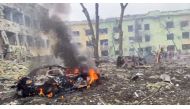 A car burns after the destruction of Mariupol children's hospital as Russia's invasion of Ukraine continues, in Mariupol, Ukraine, March 9, 2022 in this still image from a handout video obtained by Reuters. Ukraine Military/Handout via REUTERS 