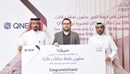 Adel Ali Al Malki, GM Group Retail at QNB awards the 1 million Life Rewards points to Moustafa Kamal Ibrahim, in the presence of a representative from the Ministry of Commerce and Industry. 